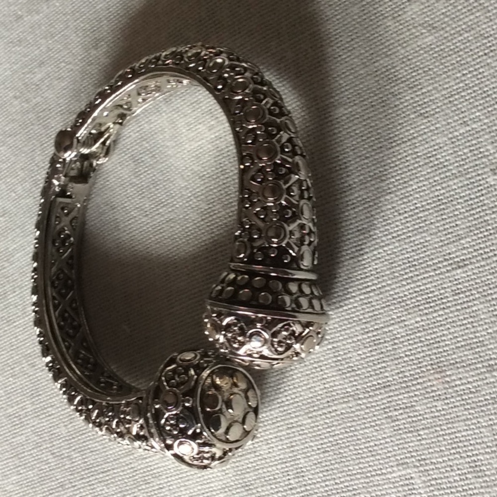 Silver tone bangle bracelet.